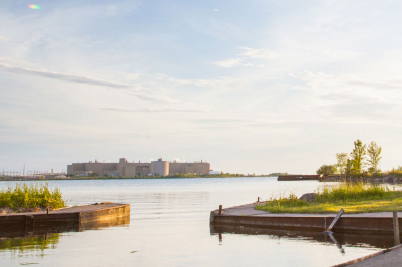 A photograph of Bruce A at Bruce Power from across a body of water.